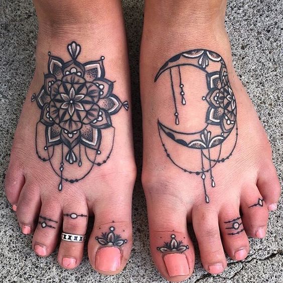 blakc and white foot mandala tattoo