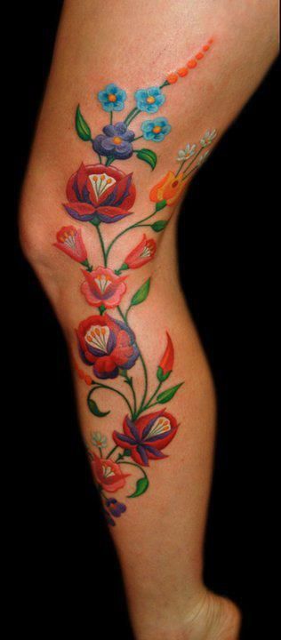 colorful flower tattoo on leg