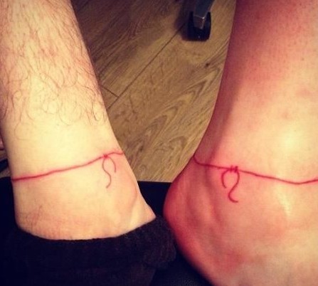 red string couple tattoo