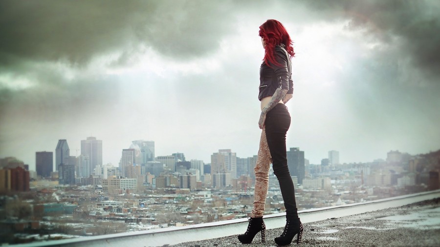 red hair girl tattoo looking at the city