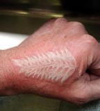 white ink tattoo leaf