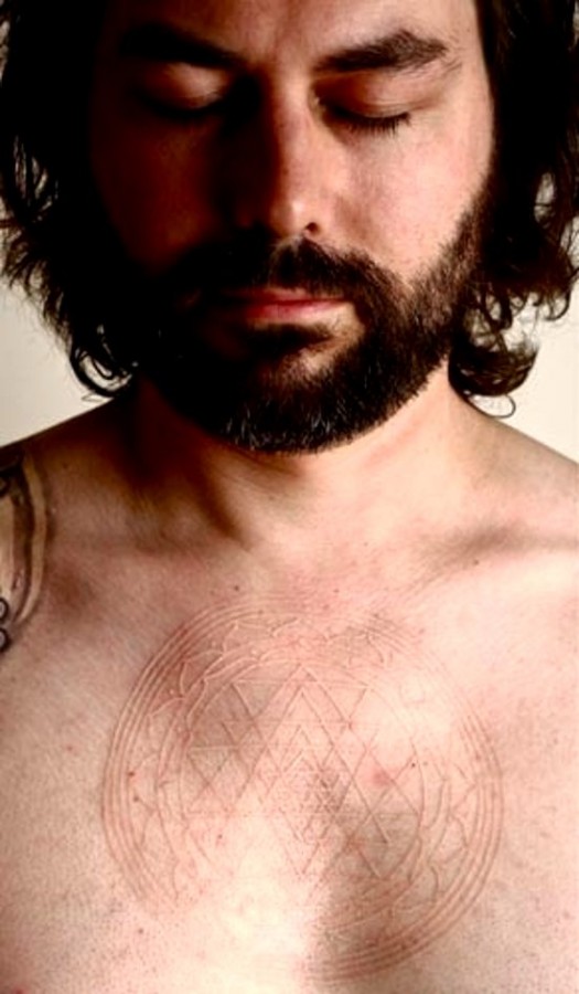 white ink tattoo on a chest