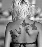 black and white photo buttreflies back tattoo