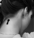 black and white photo key hole back neck tattoo