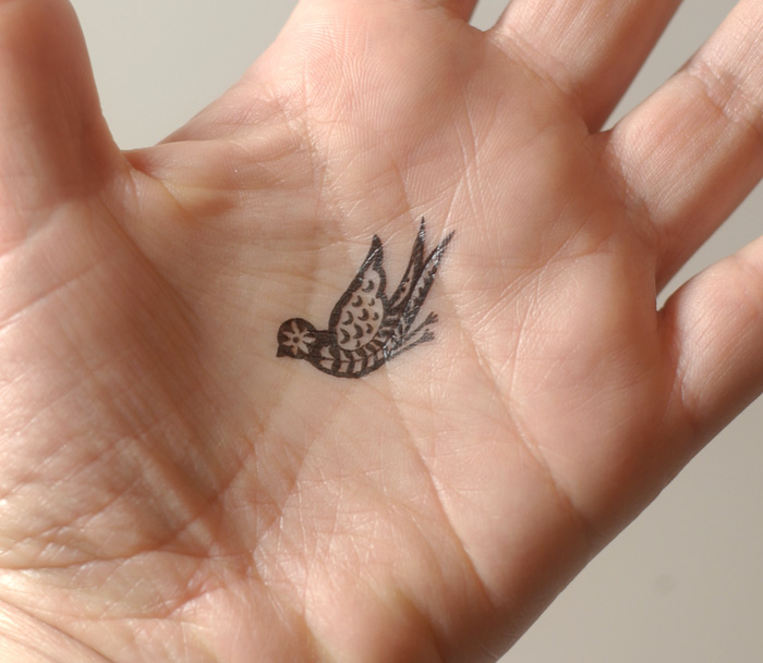 elegant bird tattoo on hand