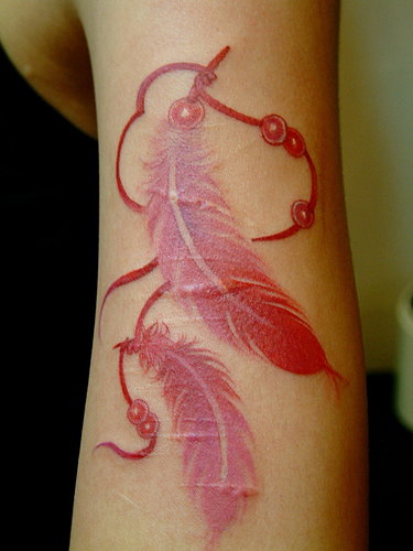 red ink tattoo feathers