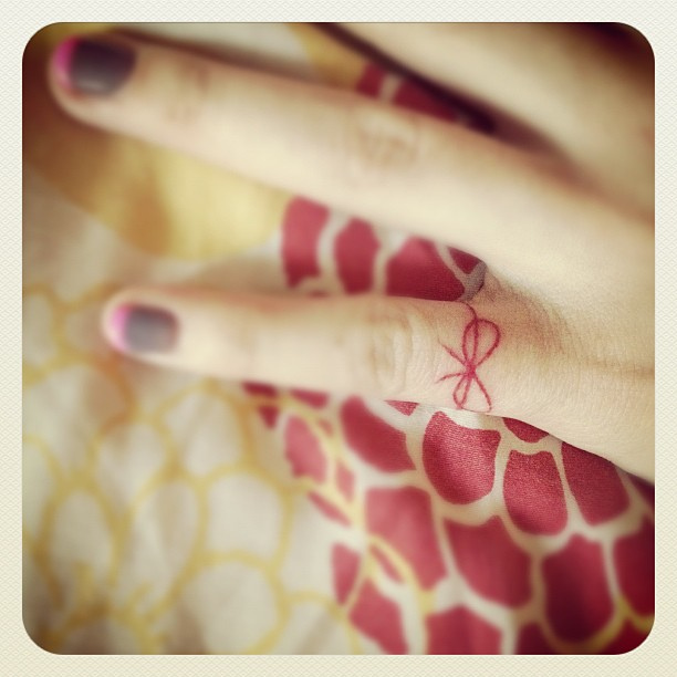 red ink tattoo tiny ribbon