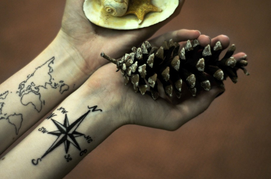 travel tattoo world map and compass pinecone