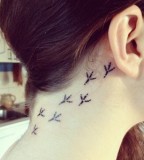 behind ear tattoo bird footprints