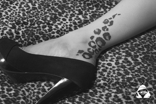 leopard print tattoo on leg black high heel