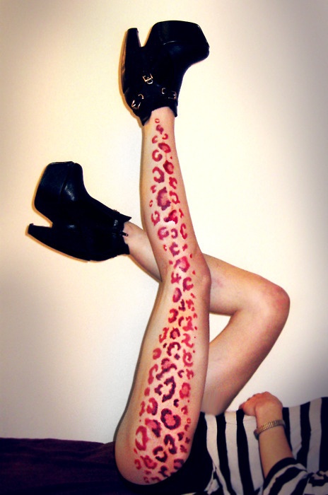 red leopard print tattoo on leg