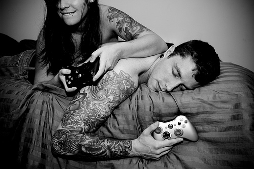 tattooed couple playing video games