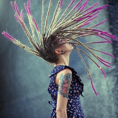 tattooed girl with dreadlocks colorful