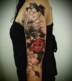 arm sleeve tattoo red flower by guy le tattooer