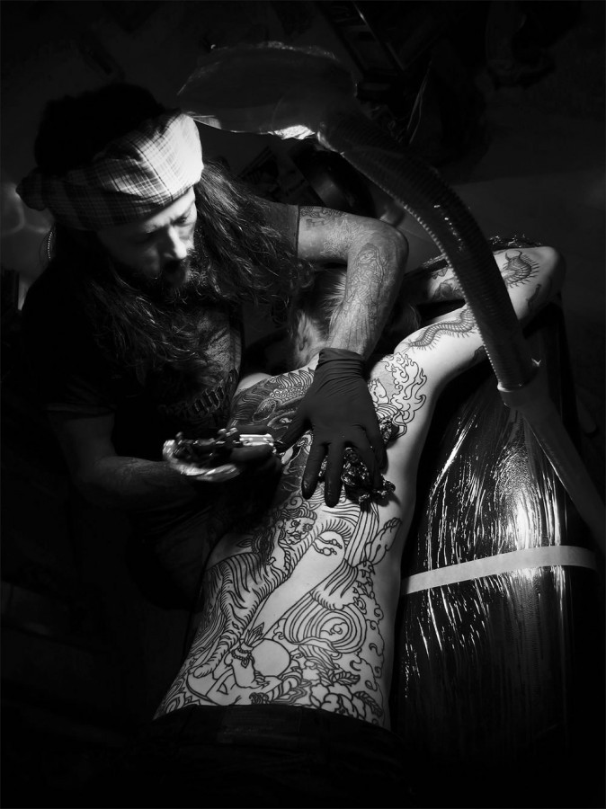 guy le tattooer working on full back piece