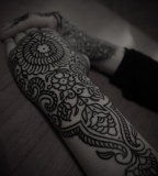 ornamental pattern hand and arm sleeve tattoo by guy le tattooer