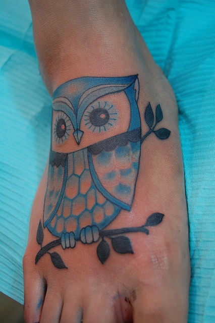 Blue owl tattoo on foot