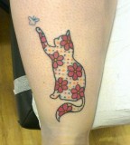 Red flowers and cat tattoo