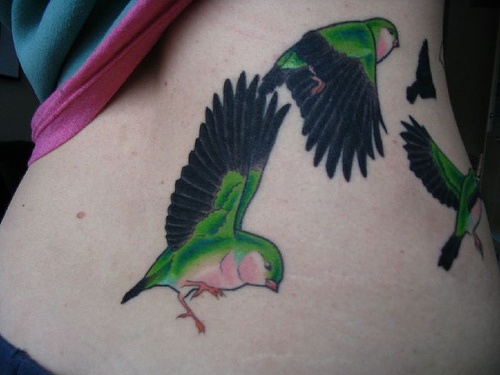 green tattoo flying birds