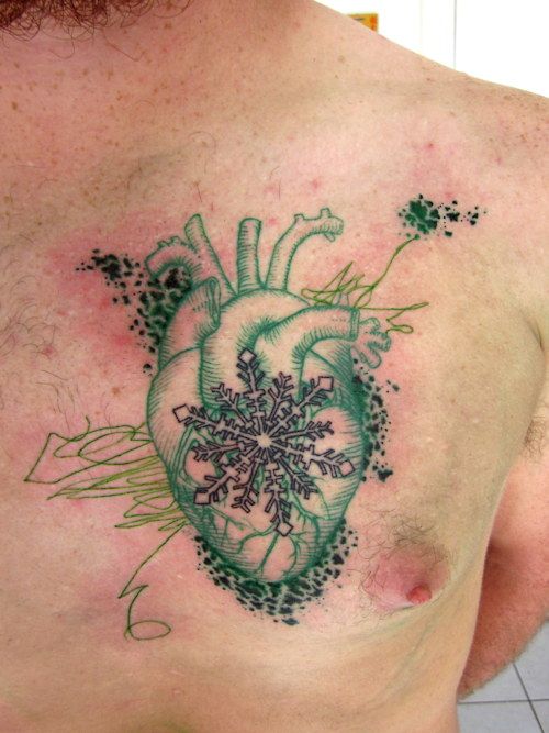 green tattoo heart with snowflake on chest