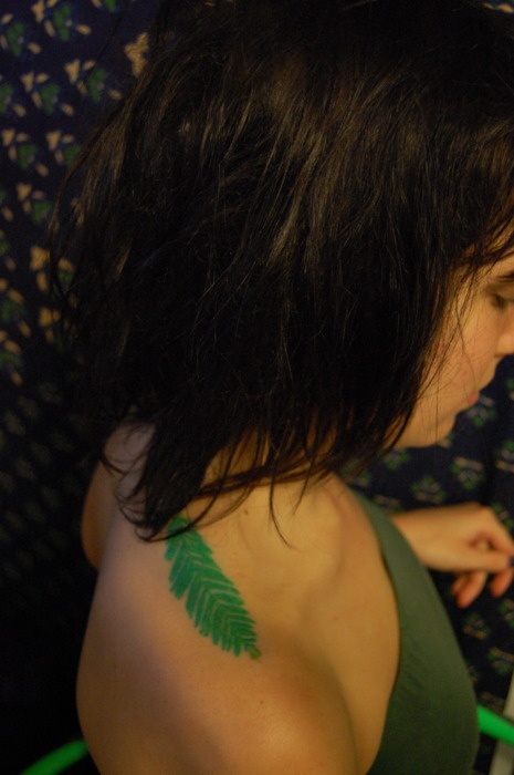 green tattoo redwood leaf on shoulder