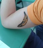 pop art tattoo banana on arm