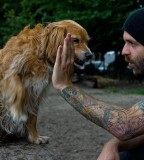 tattoos for men guy high fives dog