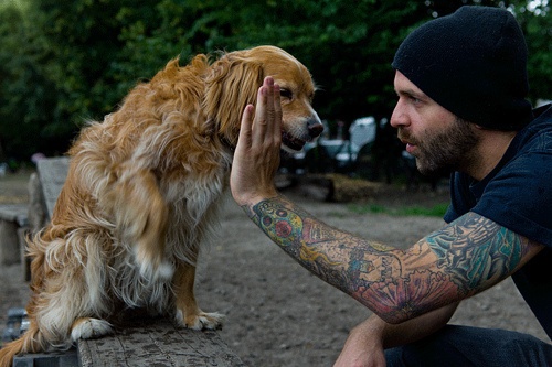 tattoos for men guy high fives dog