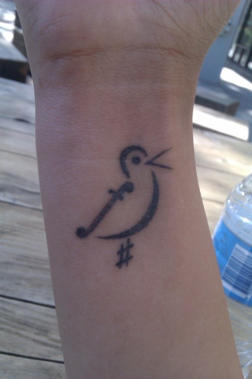 Bird symbol of music tattoo