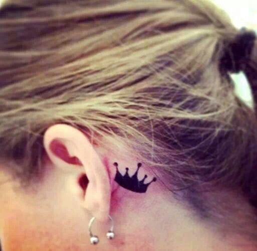 Black crown tattoo near ear