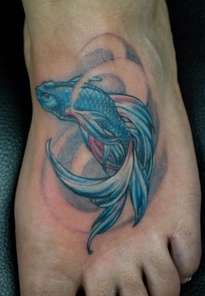 Blue fish tattoo on foot