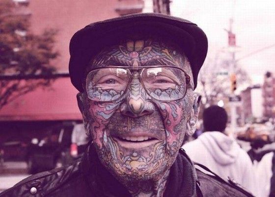 Colorful tattoos on old men face