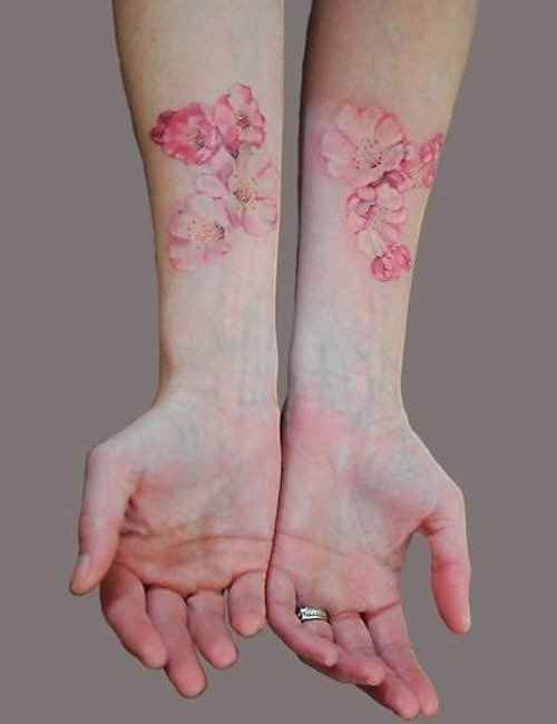 Flowers on arm pink tattoo