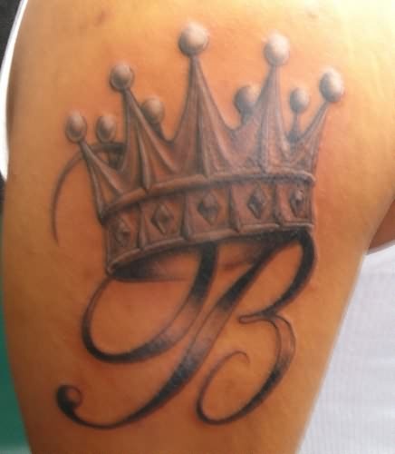 Letter and crown tattoo