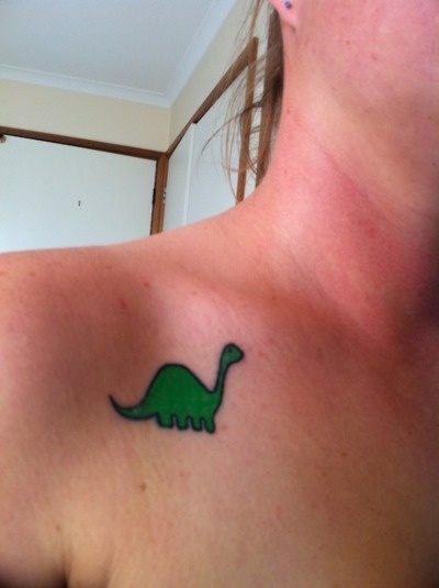 Lovely green dinosaur tattoo