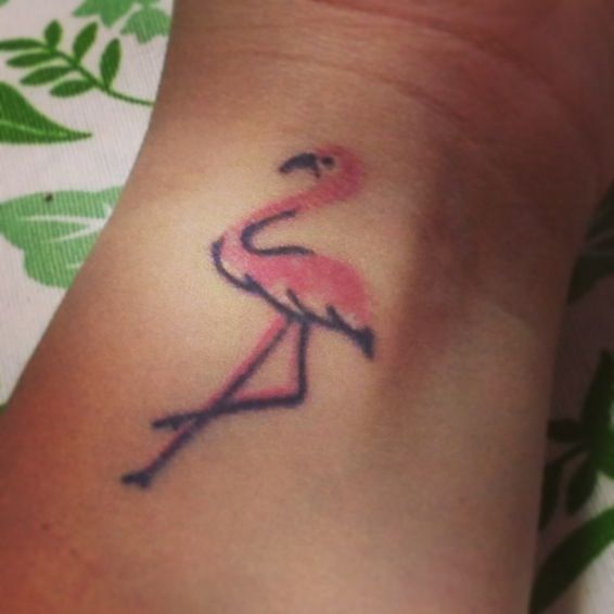 Pink and black flamingo tattoo on hand