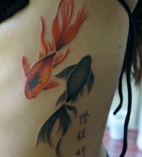 Red and black fish tattoo