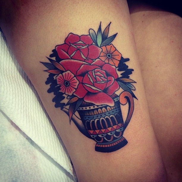 Red flowers tattoo by Kirk Jones