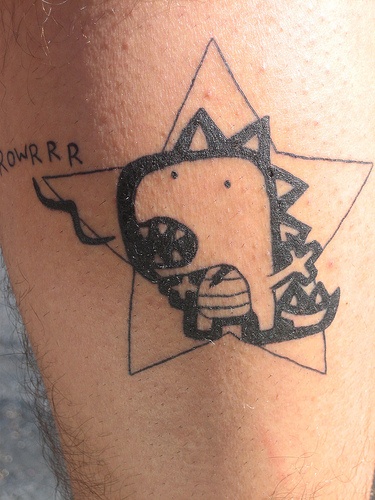 Star and dinosaur tattoo