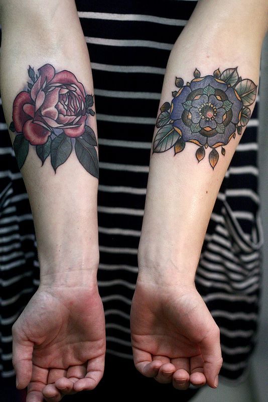 alice carrier tattoo red and blue flowers on inside arms