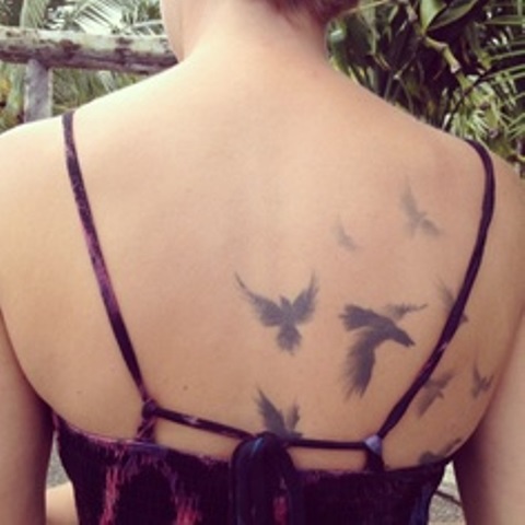 modern tattoo subtle birds on back