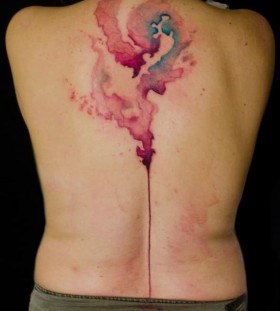 watercolor stain tattoo on back by klaim