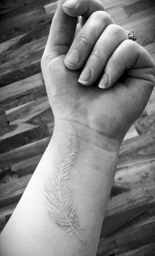 wrist tattoo white ink feather