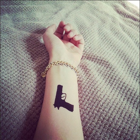 Black arm guns tattoo