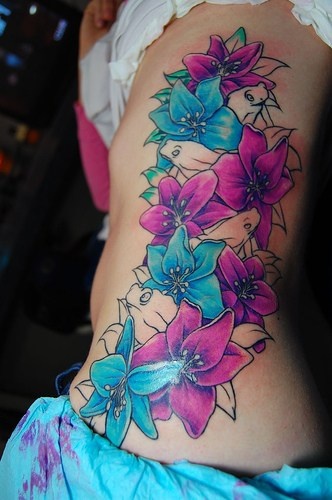 Blue and pink hip tattoo