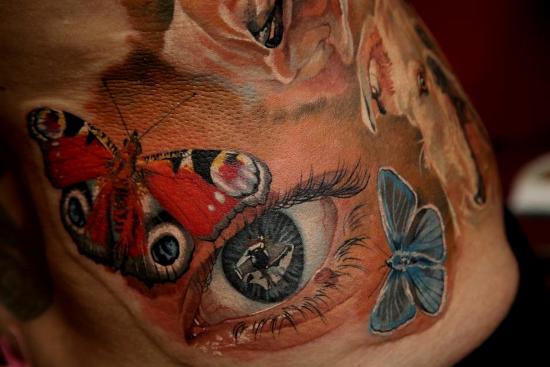 Butterflies and eye photorealistic tattoo