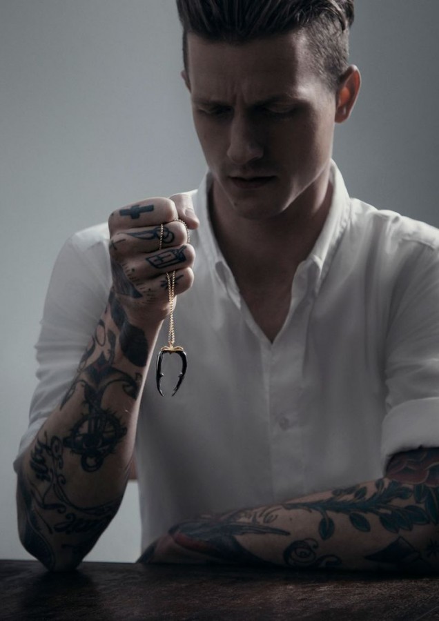 Man with tattoos and necklace