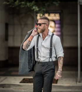 Man with tattoos in a suit