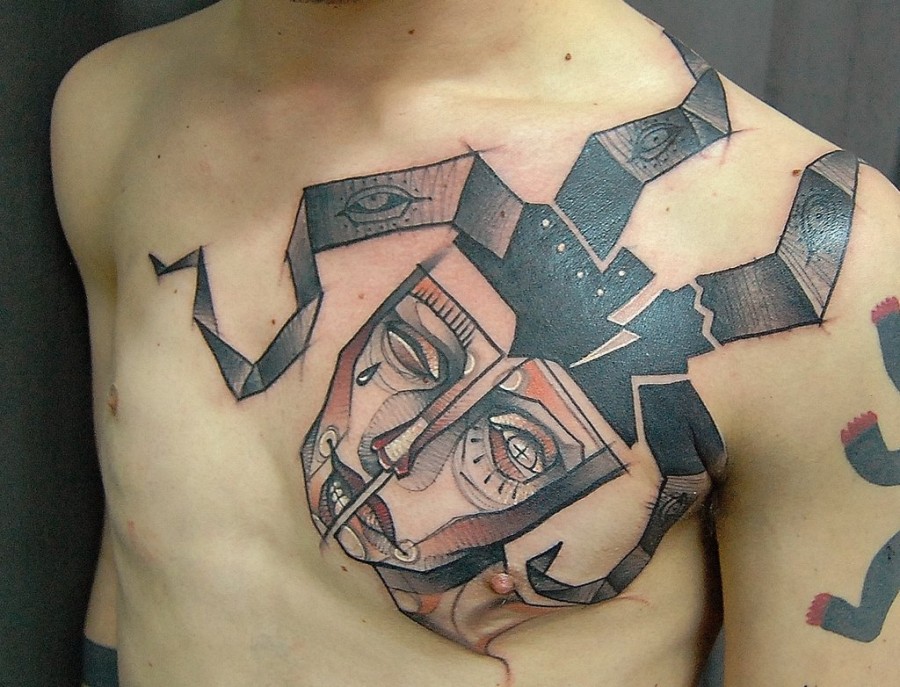 Mask on chest tattoo by Jukan