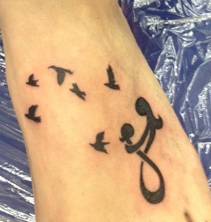 Mother and daughter symbols tattoo